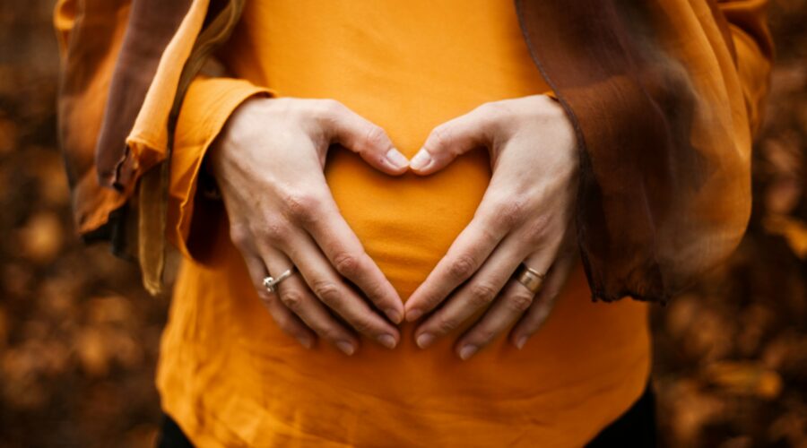 pregnant woman with hands on stomach